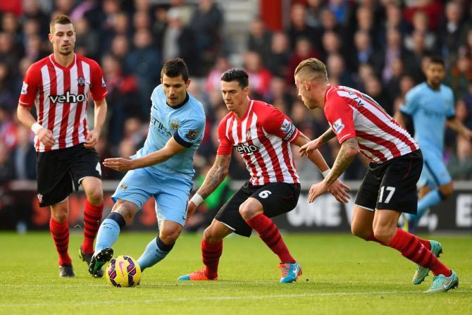 Sergio Aguero of Manchester City takes on Morgan Schneiderlin (left), Jose Fonte (2nd from) and Toby Alderweireld of Southampton (right) during the Barclays Premier League match