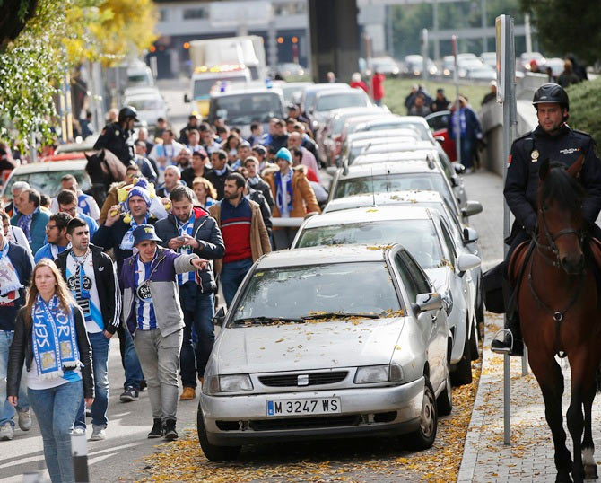 Spanish police escort Deportivo Coruna fans after their Spanish first division match against Atletico Madrid