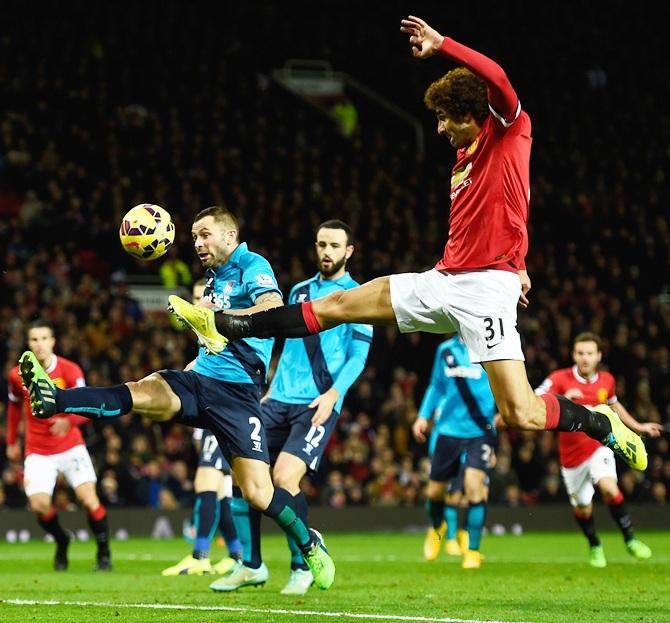 Phil Bardsley of Stoke City competes with Marouane Fellaini of Manchester United