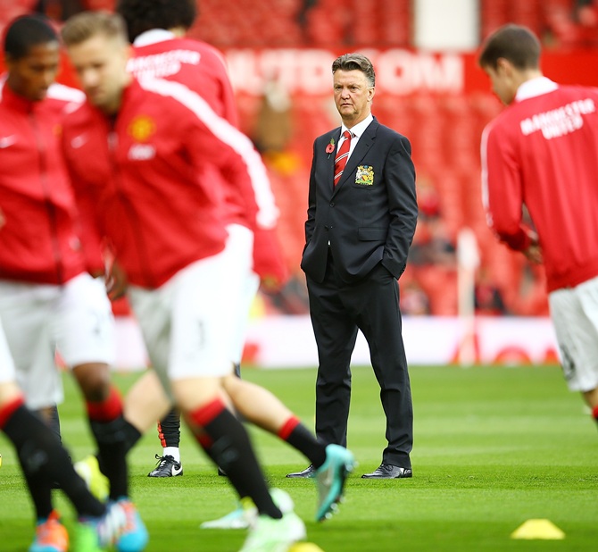 Manchester United Manager Louis van Gaal watches his players warm up