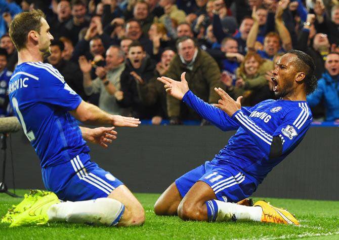 Chelsea's Didier Drogba celebrates with teammate Branislav Ivanovic after scoring against Tottenham Hotspur during their English Premier League match at Stamford Bridge in London on Wednesday