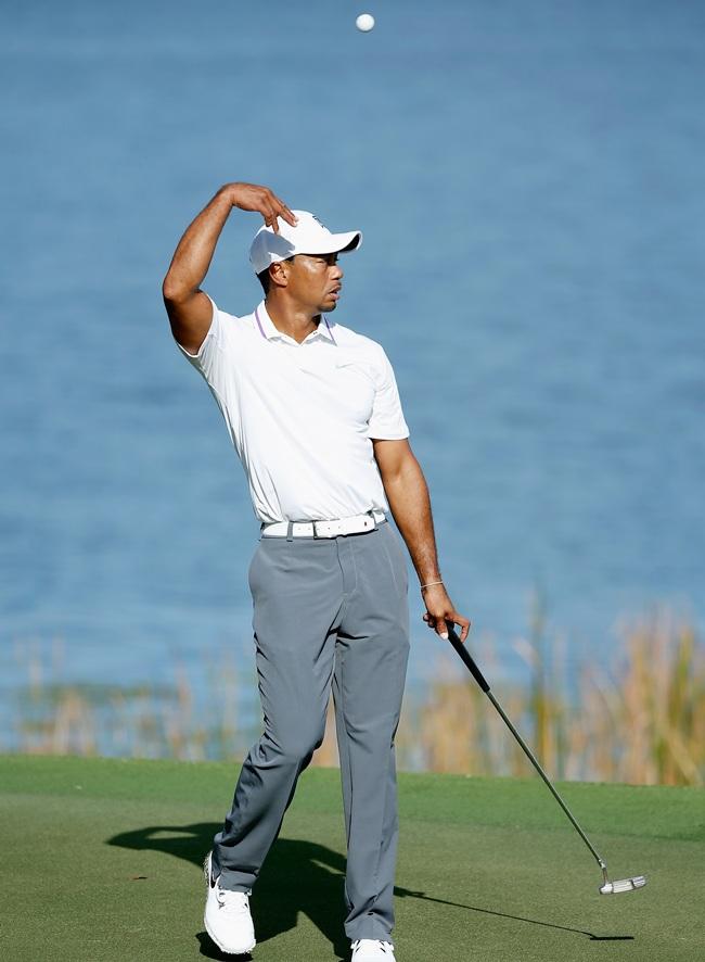 Tiger Woods walks across a green during the pro-am prior to the start of the Hero World   Challenge 