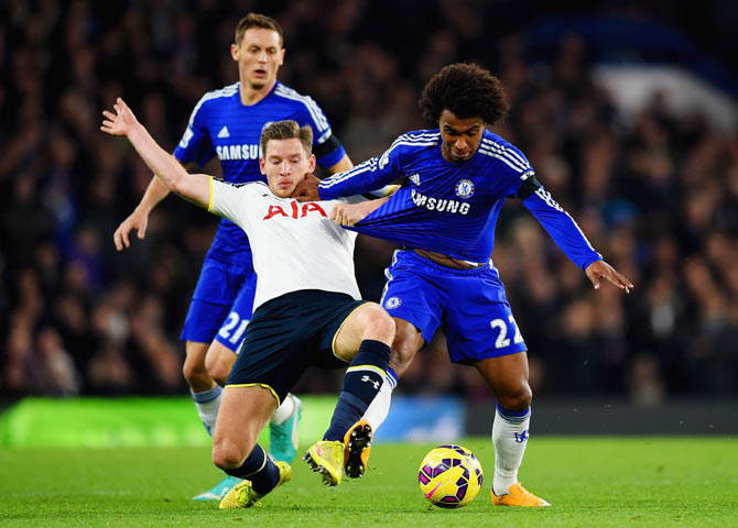 Jan Vertonghen of Spurs pulls on the shirt of Willian of Chelsea as they vie for possession during their match on Wednesday