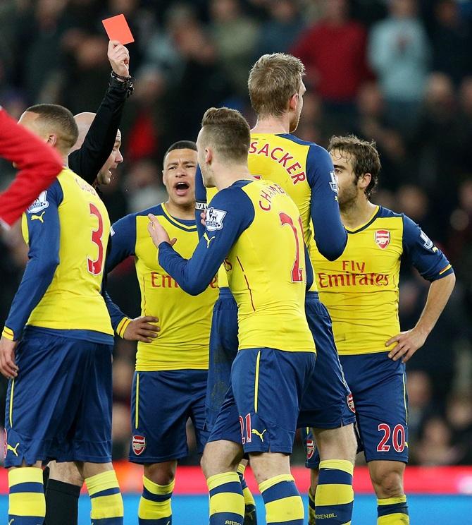 Calum Chambers of Arsenal is shown a red card by Referee Anthony Taylor