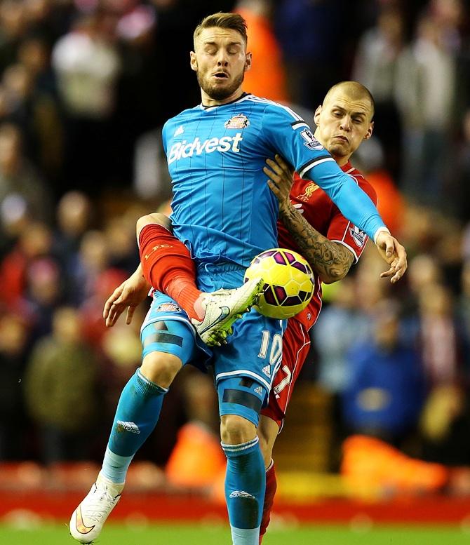 Connor Wickham of Sunderland battles for the ball with Martin Skrtel of Liverpool