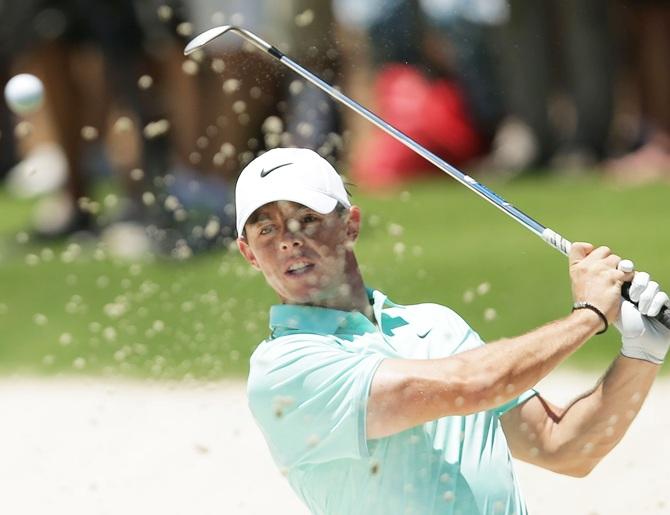 Rory McIlroy of Northern Ireland plays a bunker shot