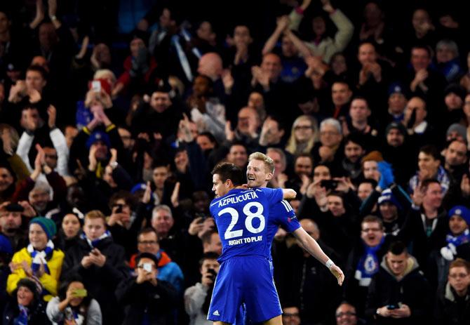 Andre Schuerrle of Chelsea celebrates with teammate Cesar Azpilicueta #28 after scoring his team's second goal against Sporting Clube de Portugal