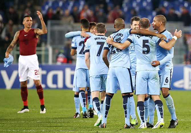 Manchester City players celebrate at the end of their Champions League Group E match against AS Roma at the Olympic stadium in Rome on Wednesday