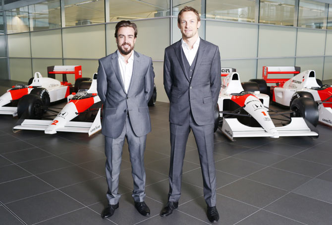 Formula One drivers Fernando Alonso (L) and Jenson Button pose together as McLaren-Honda announces its new driver line-up for 2015