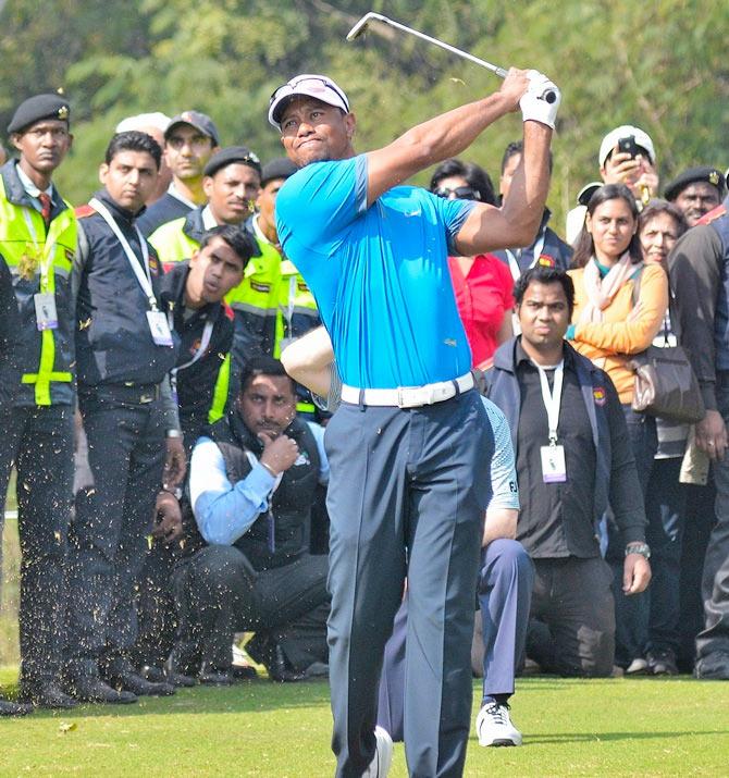 Tiger Woods of the US tees off during an exhibition match at the Delhi Golf Club