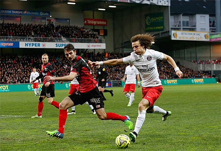 PSG's David Luiz (right) is challenged by Guingamp players during their Ligue 1 match on Sunday