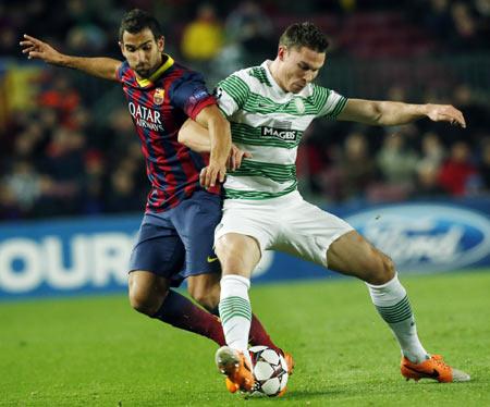 Barcelona's Martin Montoya (left) challenges Celtic's Derk Boerrigter