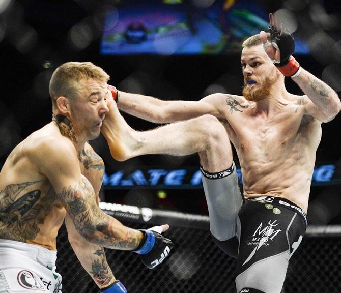 Britain's Mike Wilkinson gets a kick to the head by Sweden's   Niclas Backstrom in their featherweight MMA bout at the Ultimate Fighting Championship 