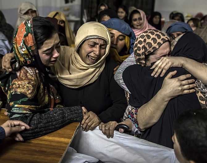 Women mourn their relative Mohammed Ali Khan, 15, a student who was killed during an attack 