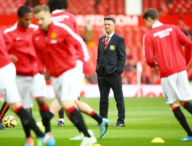 Manchester United Manager Louis van Gaal watches his players warm up