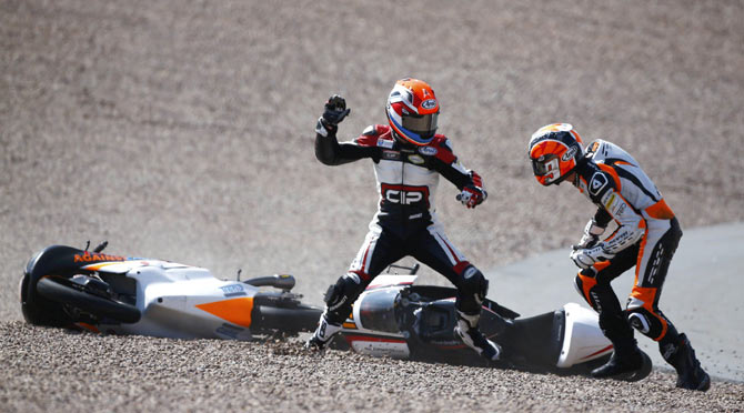 Mahindra Moto3 rider Bryan Schouten of the Netherlands fights with compatriot Kalex KTM Moto3 rider Scott Deroue (right) after they crashed during the German Grand Prix at the Sachsenring circuit in the eastern German town of Hohenstein-Ernstthal on July 13