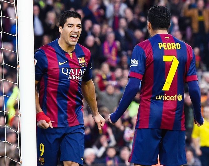 Luis Suarez of FC Barcelona celebrates with his teammate Pedro Rodriguez of FC Barcelona