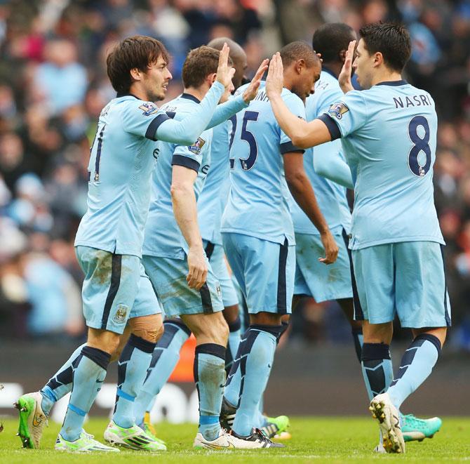 David Silva, left, of Manchester City celebrates the opening goal with Samir Nasri