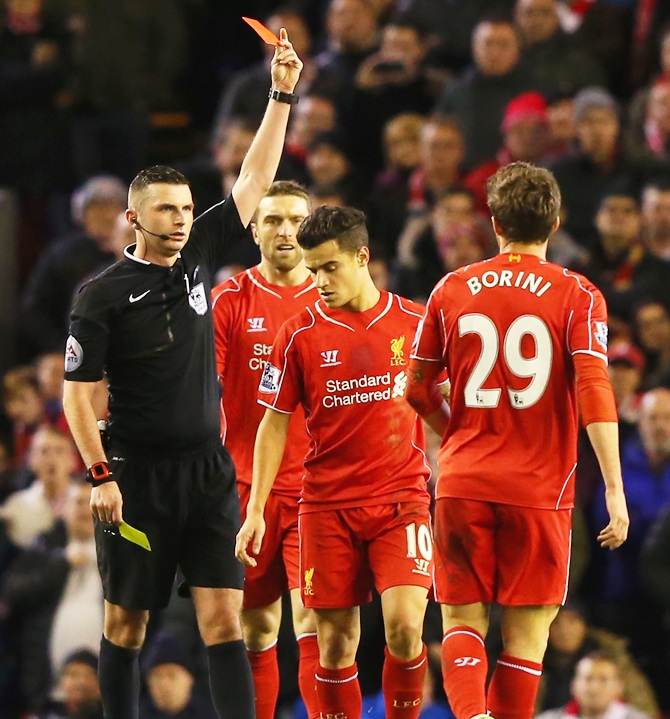 Fabio Borini of Liverpool is shown the red card by referee Michael Oliver