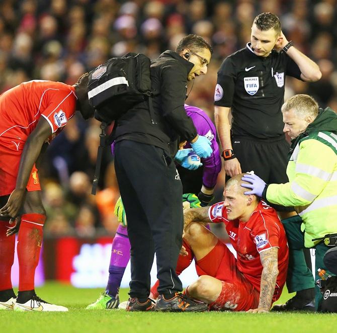 Martin Skrtel of Liverpool receives treatment for a head wound