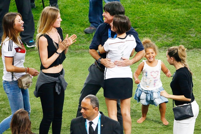 Head coach Joachim Loew of Germany hugs Kathrin Gilch, girlfriend of Manuel Neuer