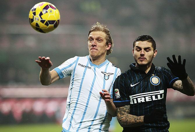 Dusan Basta of SS Lazio competes for the ball with Mauro Emanuel Icardi of Inter Milan during the Serie A match at Stadio Giuseppe Meazza in Milan on Sunday