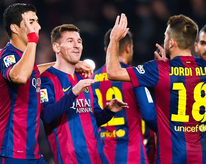 Lionel Messi of FC Barcelona celebrates with his teammates