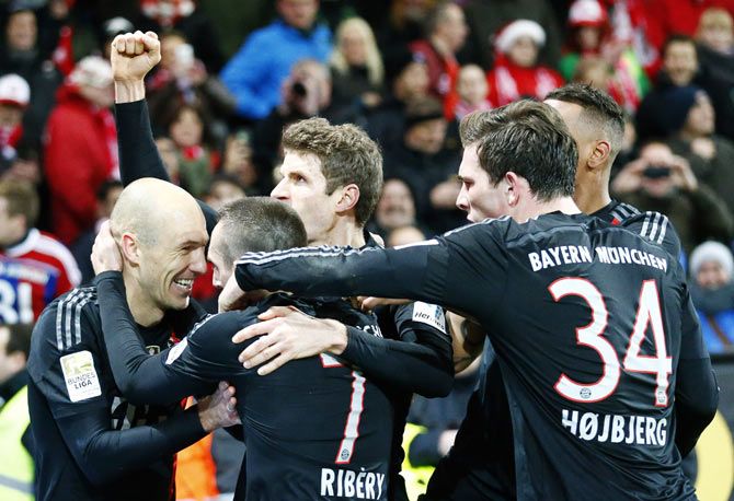 Bayern Munich's Arjen Robben (left) celebrates with his teammates after scoring against FSV Mainz 05 during their Bundesliga match in Mainz on Friday