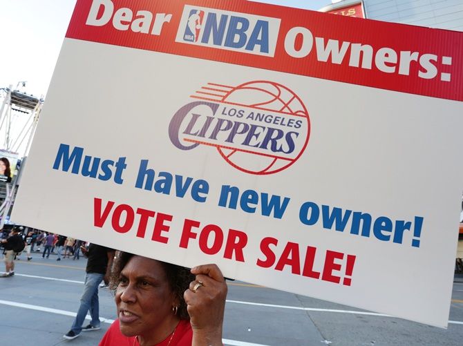 Susan Wright holds a sign protesting racist comments made by LA Clippers owner Donald Sterling