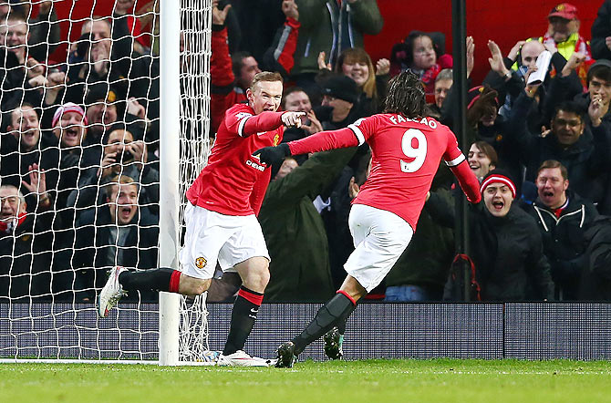 Wayne Rooney of Manchester United celebrates with teammate Radamel Falcao (right) after scoring a goal during their English Premier League match