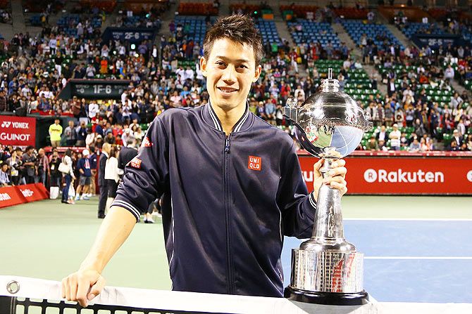 Winner Kei Nishikori of Japan poses with his trophy after winning the Rakuten Japan Open at Ariake Colosseum in Tokyo on October 5