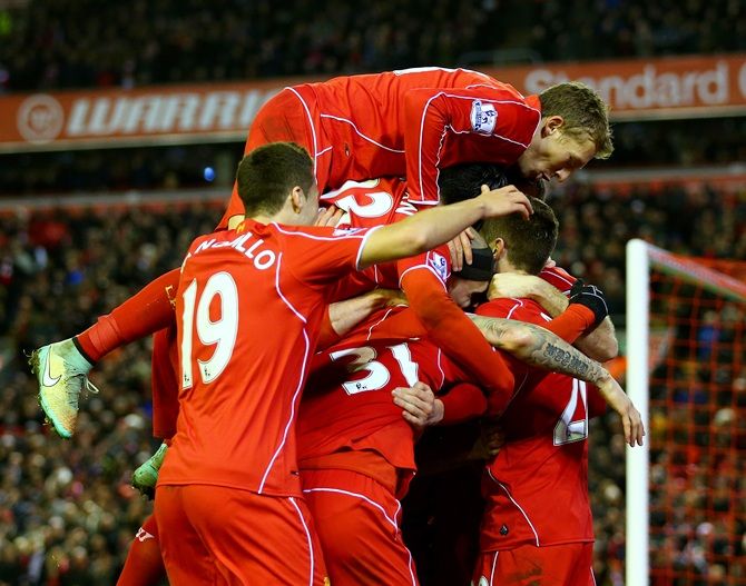 Adam Lallana of Liverpool celebrates with team-mates after scoring his team's second goal
