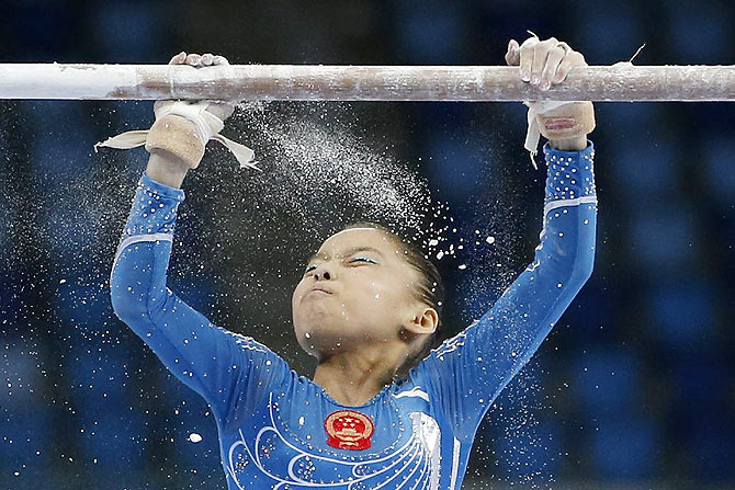 China's Shang Chunsong prepares to compete in the uneven bars event of the women's individual all-around final artistic gymnastics competition at the Namdong Gymnasium Club during the 17th Asian Games in Incheon on September 23
