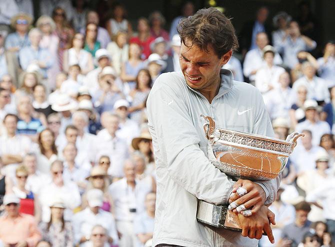 Rafael Nadal of Spain cries as he attends the trophy ceremony after defeating Novak Djokovic of Serbia to win the French Open men's singles final at the Roland Garros stadium in Paris on June 8