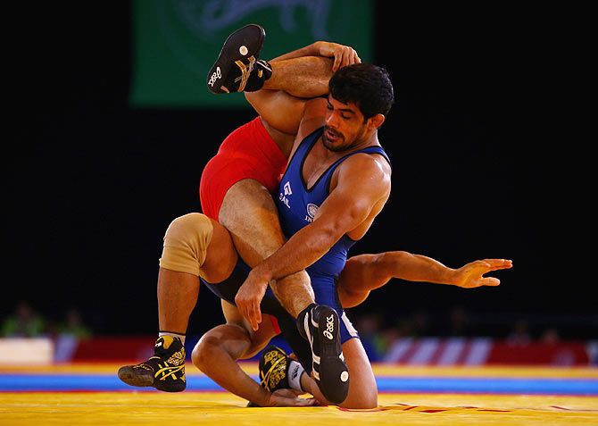 Sushil Kumar of India (blue) on his way to beating Qamar Abbas of Pakistan in the 74kg Freestyle Wrestling Gold medal match during the Glasgow 2014 Commonwealth Games on July 29