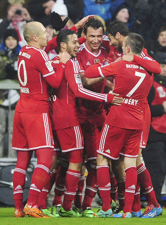 Bayern Munich's players celebrate a goal against Eintracht Frankfurt during their Bundesliga match in Munich on Sunday