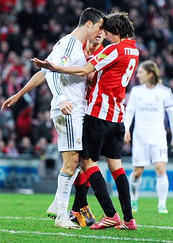 Cristiano Ronaldo (L) of Real Madrid CF gets into a tussle with Ander Iturraspe of Athletic Club Bilbao during their La Liga match at San Mames Stadium in Bilbao on Sunday
