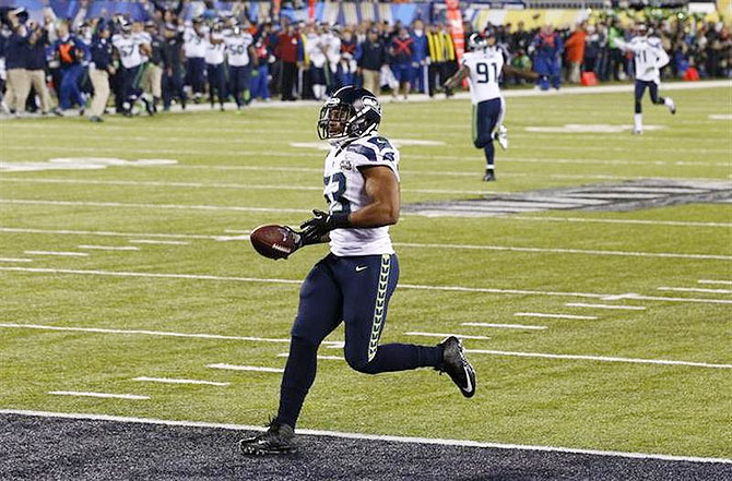 Seattle Seahawks' Malcolm Smith scores a touchdown against the Denver Broncos on an interception in the second quarter of the NFL Super Bowl XLVIII football game in East Rutherford, New Jersey on Sunday