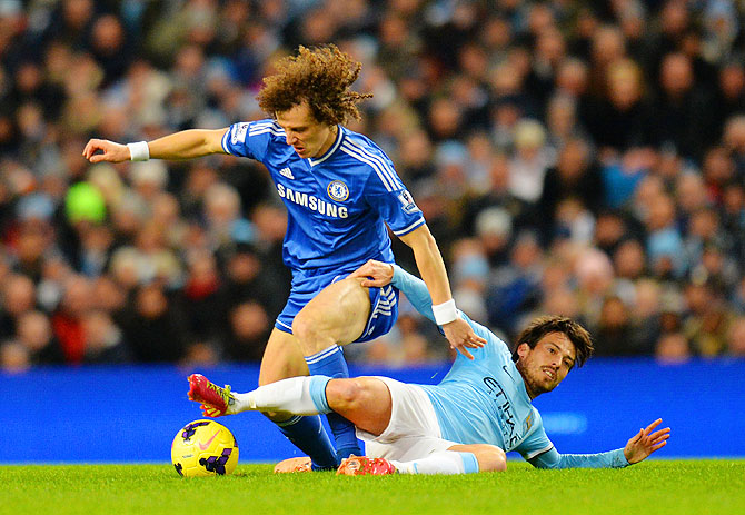 David Silva of Manchester City and David Luiz of Chelsea battle for the ball during their match on Monday