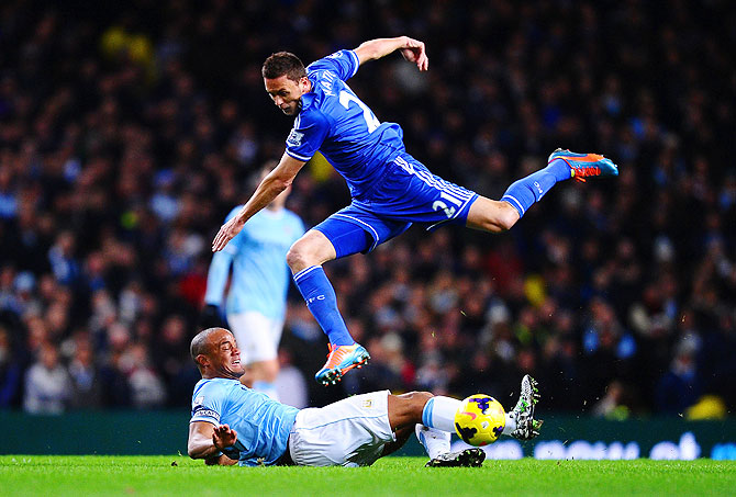 Vincent Kompany of Manchester City tackles Nemanja Matic of Chelsea on Monday