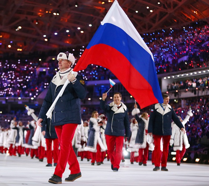 Bobsleigh racer Alexander Zubkov of the Russia Olympic team carries his country's flag during the Opening Ceremony.