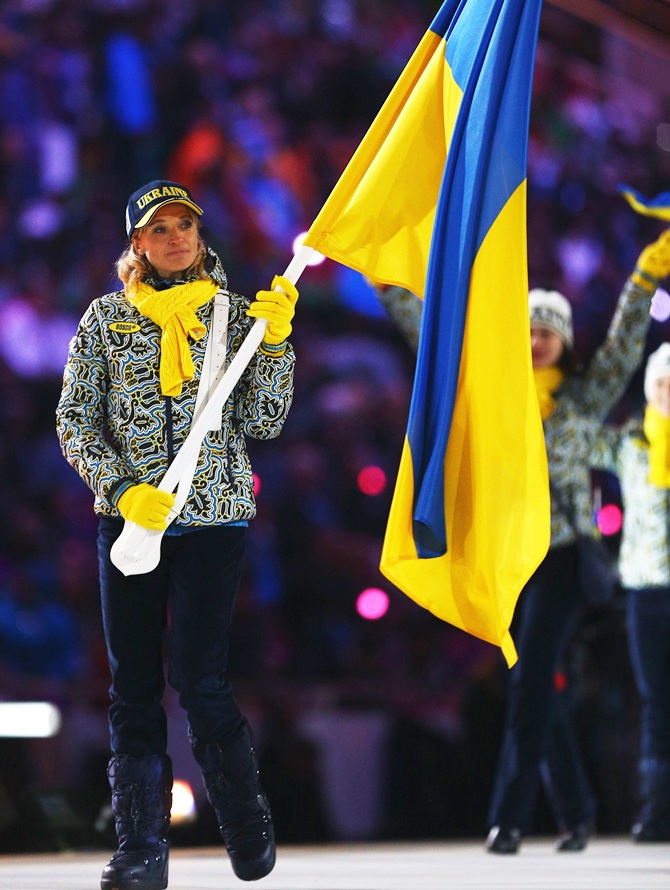 Cross country skier Valentina Shevchenko of the Ukraine Olympic team carries her country's flag.