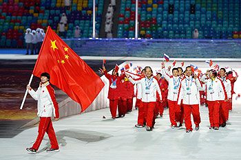 Figure skater Jian Tong of the China Olympic team carries his country's flag during the Winter Games Opening Ceremony in Sochi on Friday