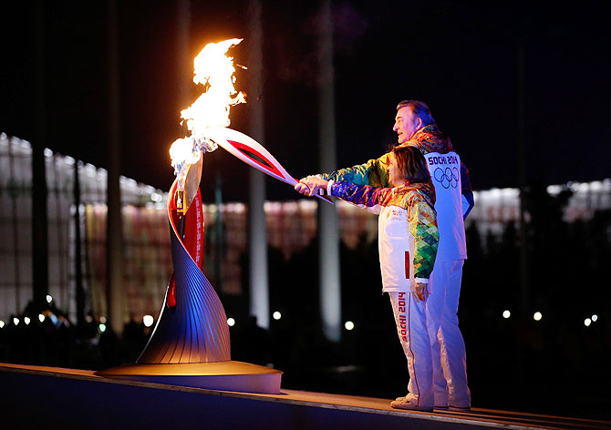 Irina Rodnina and Vladislav Tretyak light the Olympic cauldron during the opening ceremony of the 2014 Winter Olympics in Sochi on Friday