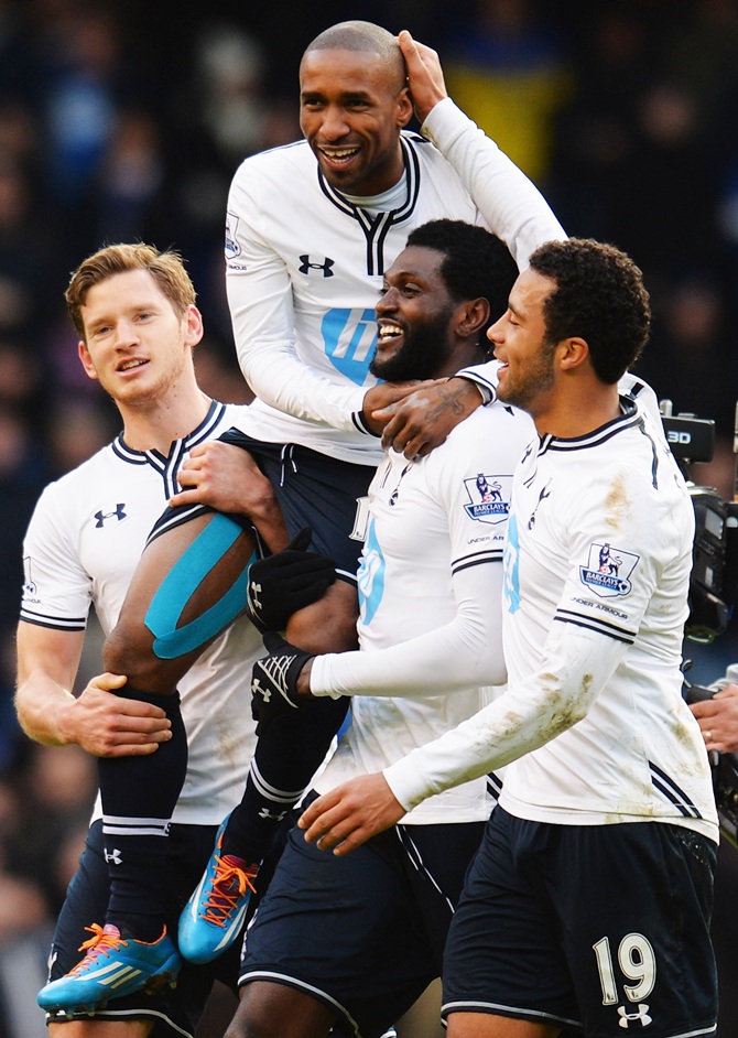 Jermain Defoe of Tottenham Hotspur is carried on the shoulders of team mates Jan Vertonghen, left, and Emmanuel Adebayor