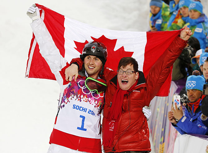 Canada's Alex Bilodeau and his brother Frederic celebrate following the freestyle skiing moguls competition at the 2014 Sochi Winter Olympic Games in Rosa Khutor on Monday