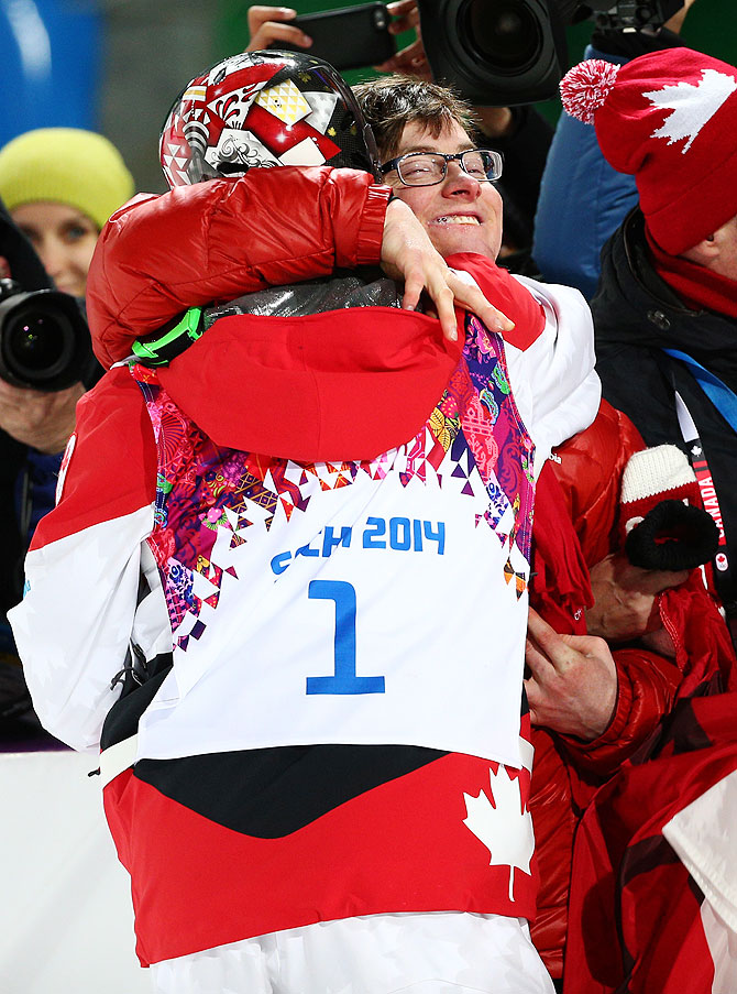 Gold medalist Alex Bilodeau of Canada celebrates with his brother Frederic after the flower ceremony for the Men's Moguls finals at Sochi 2014 Winter Olympics at Rosa Khutor Extreme Park on Monday