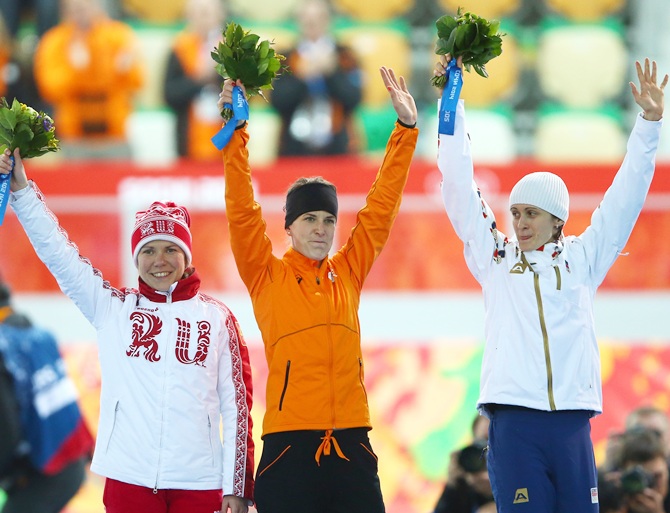 Silver medalist Martina Sablikova of the Czech Republic,right, gold medalist Irene Wust of the   Netherlands, centre, and bronze medalist Olga Graf of Russia celebrate on the podium.