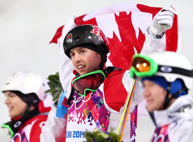 Gold medalist Alex Bilodeau of Canada, centre, celebrates.