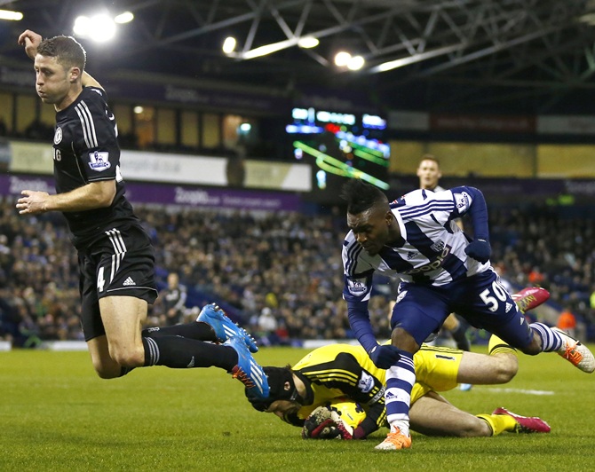 Chelsea's Gary Cahill,left, and Petr Cech, centre, challenge West Bromwich Albion's Thievy Bifouma.